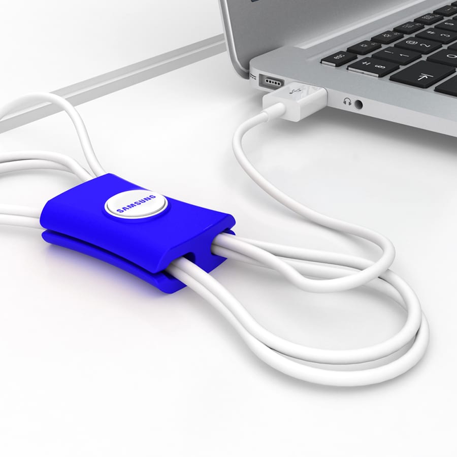 A blue cable manager with white cords, positioned near a laptop's USB port, featuring a logo.