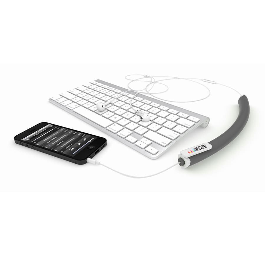 A black earbud organiser alongside a keyboard and a smartphone with earbuds connected.