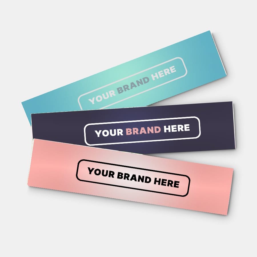 Three glossy paper stickers in teal, navy, and pink, each featuring a logo or branding space.