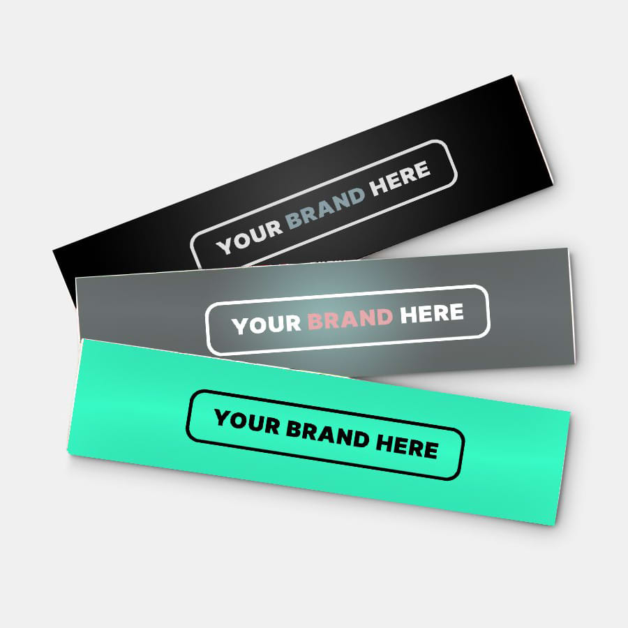 Three glossy paper stickers in black, grey, and teal, featuring placeholder branding.