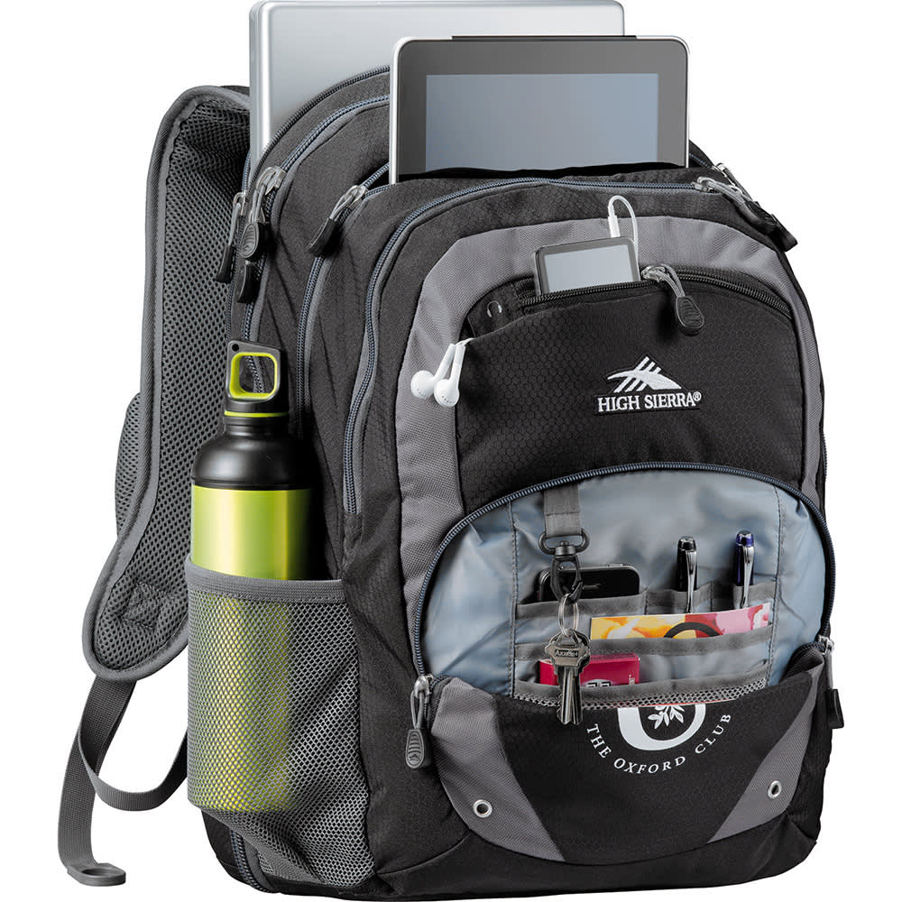 A grey backpack with padded straps and a side pocket, featuring a logo on the side.
