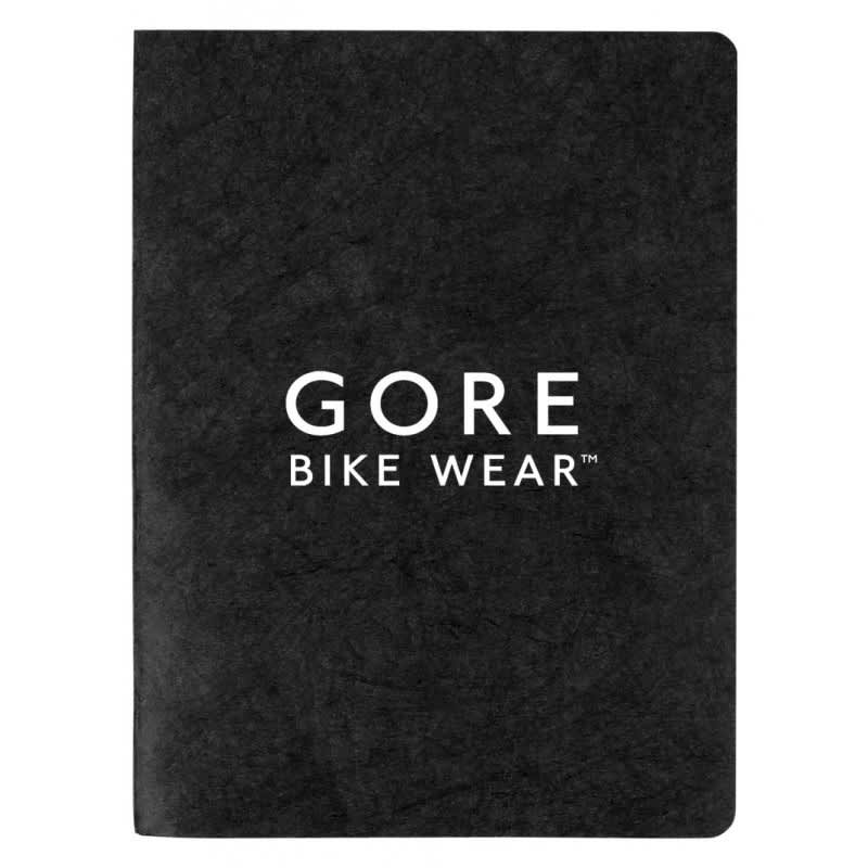 A black notebook with a textured cover featuring a logo. It has a smooth finish and blank pages inside.