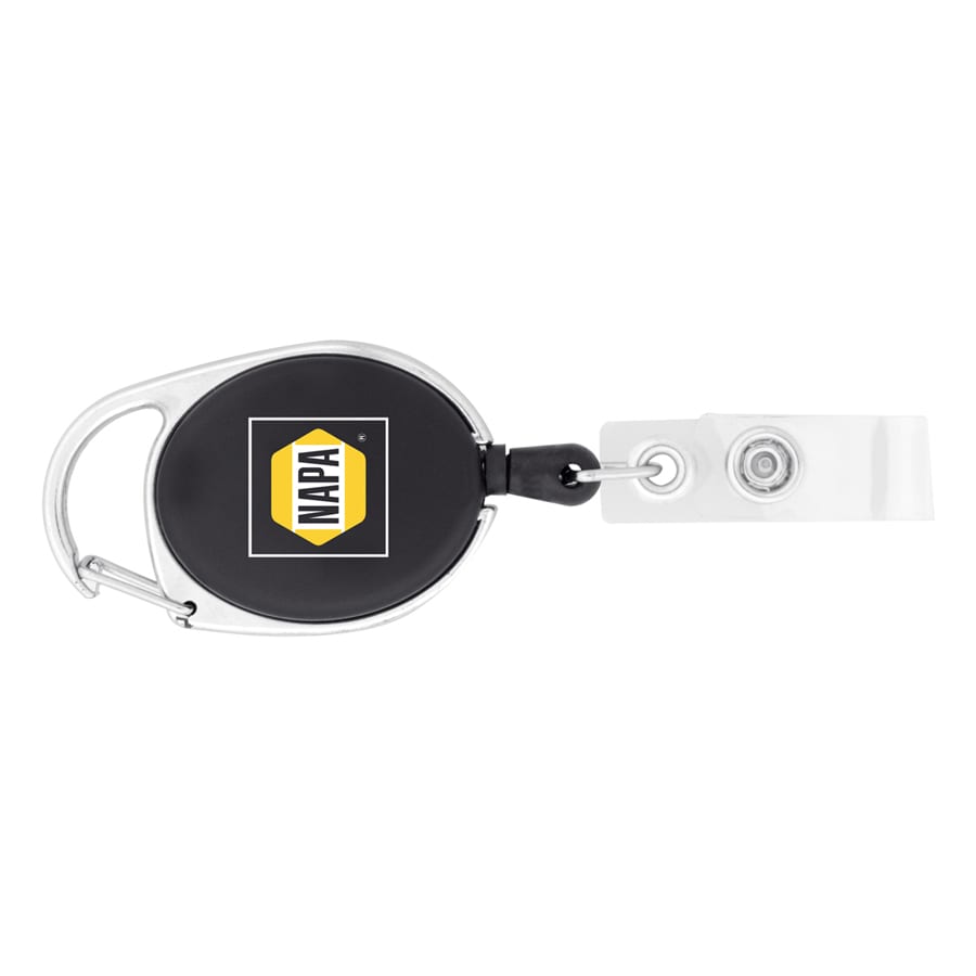 A retractable badge holder with a black casing, silver clip, and transparent strap, featuring a logo.