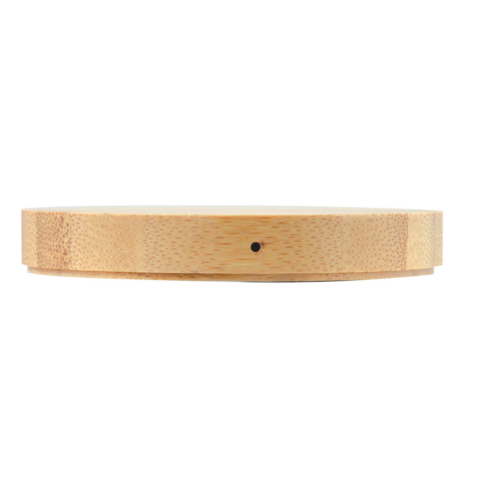 A round bamboo wireless charger with a smooth finish and a minimalist design.