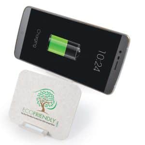 A wireless charger with a light gray base displaying an eco-friendly logo next to a smartphone showing a charging battery.