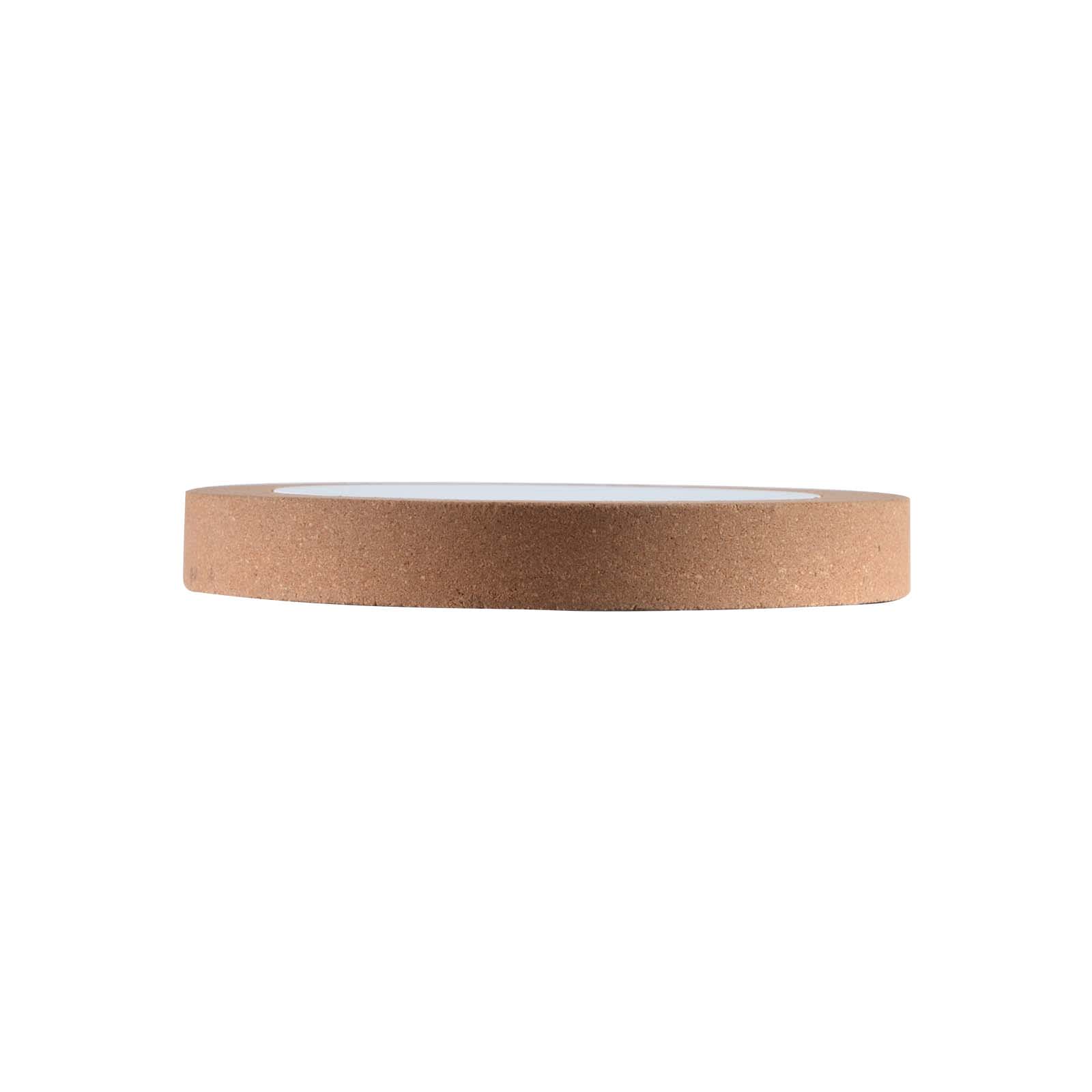 A circular wireless charger with a cork exterior and a smooth white surface on top. Features a subtle logo.