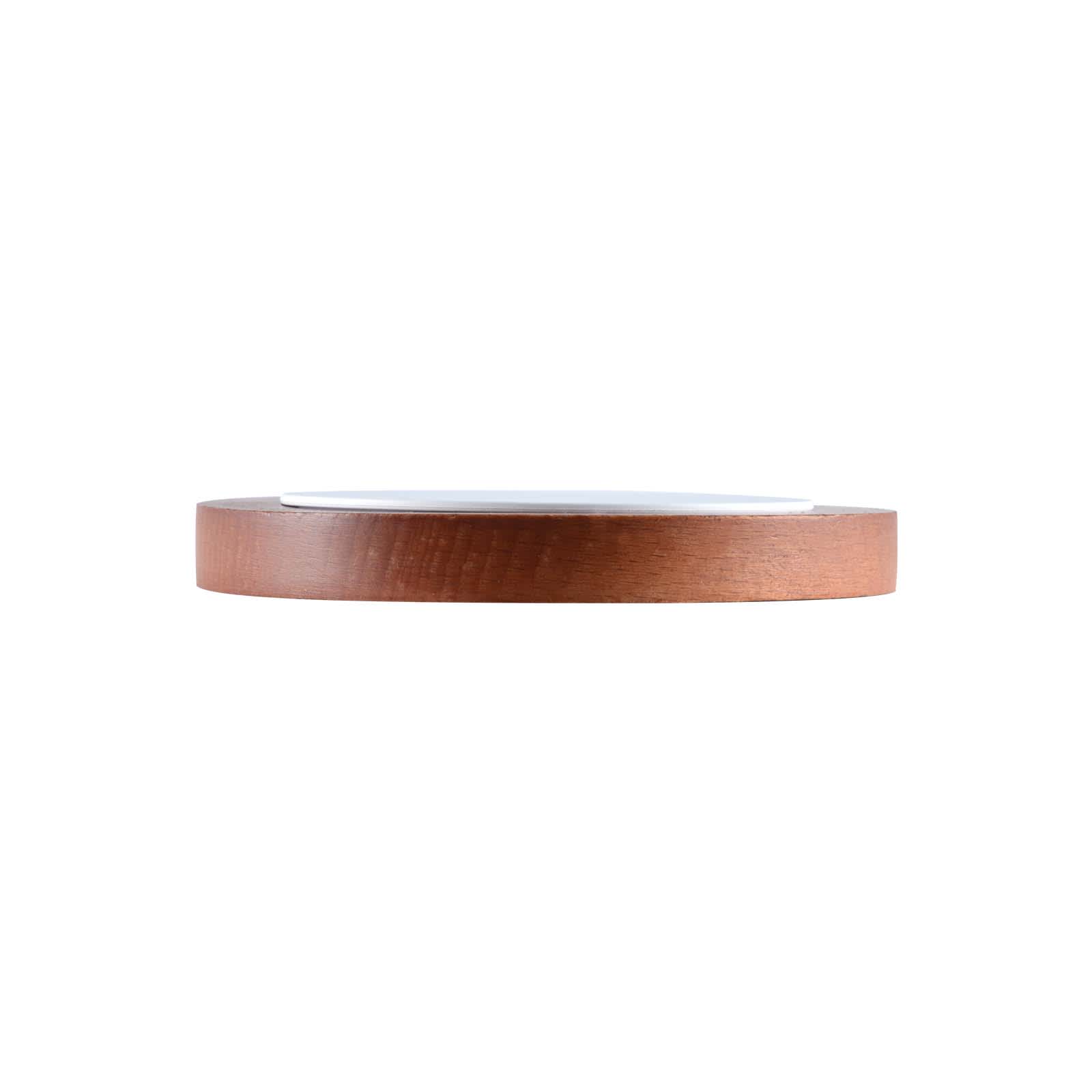 A wooden fast wireless charger with a sleek, circular design and a smooth white surface on top.