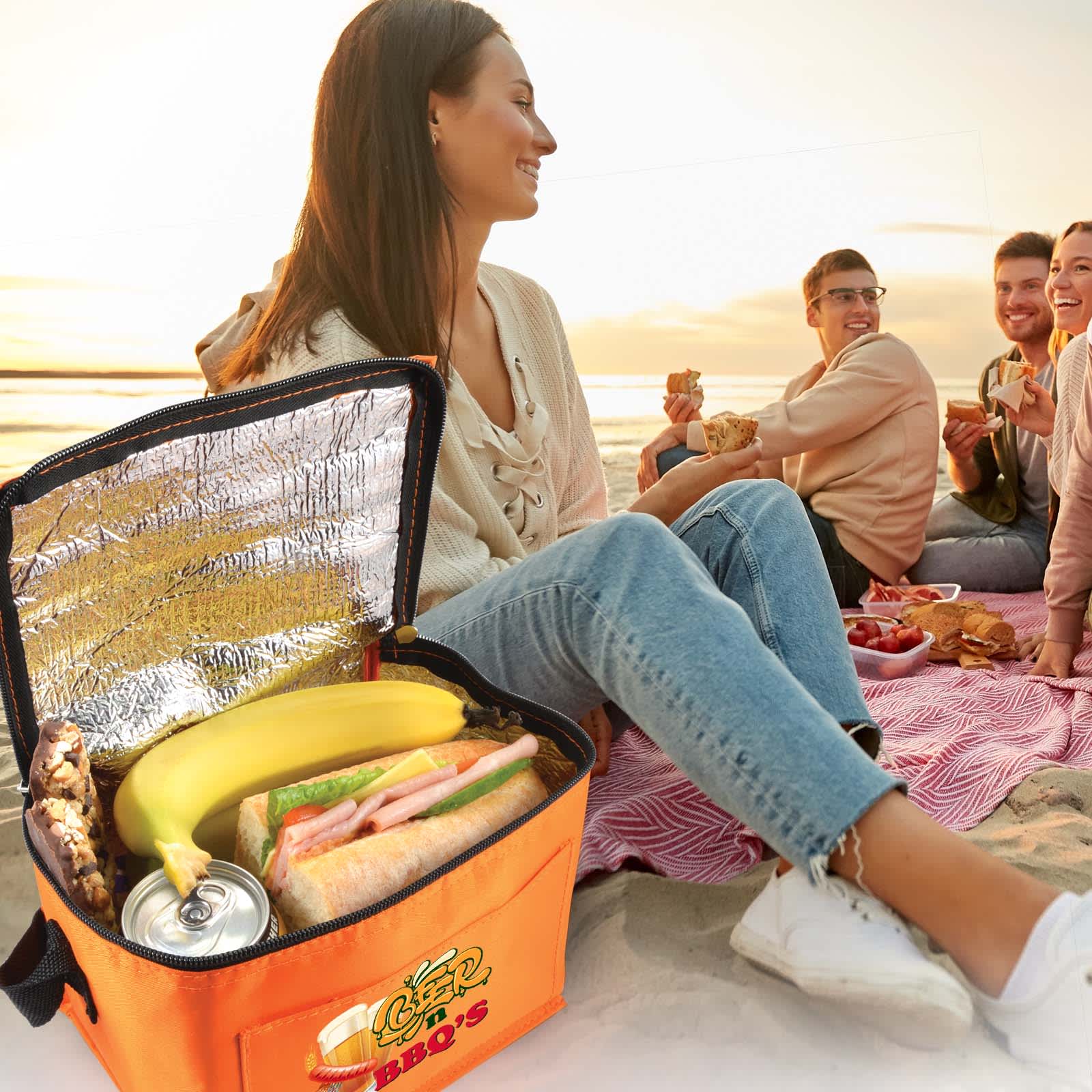 A silver cooler bag with a shiny aluminum foil lining and a tag detailing its materials and care instructions.