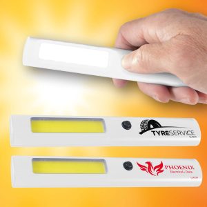 A hand holds a white LED torch with a yellow light strip, featuring two logos on its surface.