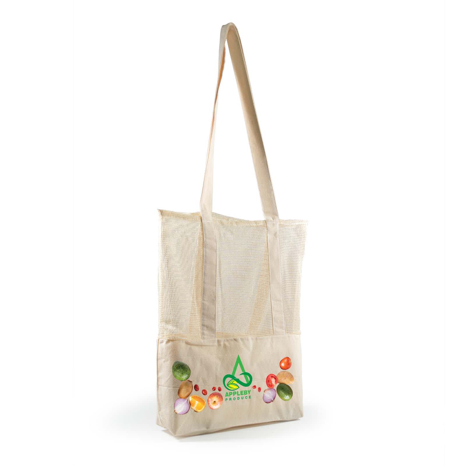 A hand holds a cream-coloured mesh tote bag with long straps, featuring a textured design.
