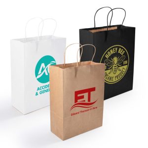 Three medium paper bags: one white with a logo, one brown with red text, and one black with a logo in yellow.
