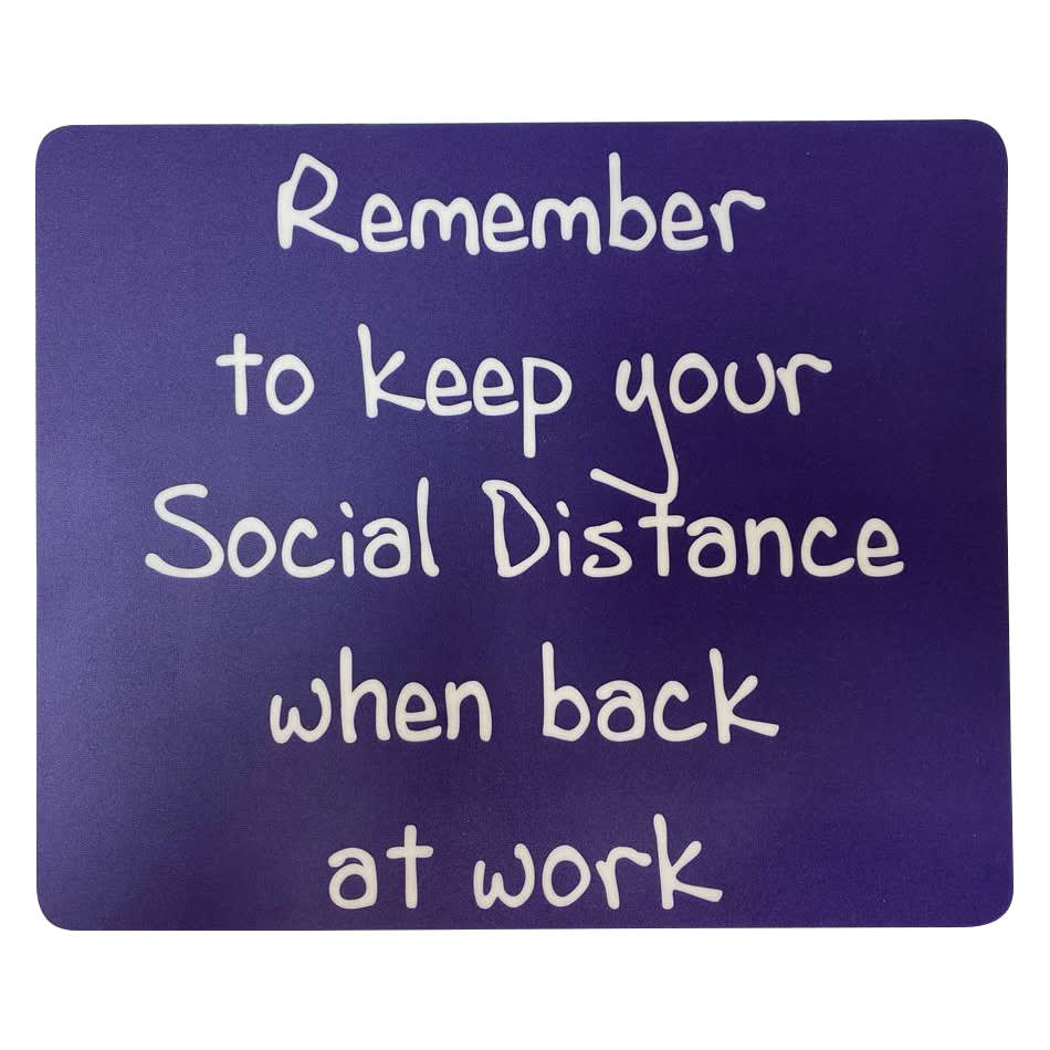 A purple mouse mat with white text reminding to keep social distance when back at work. It features a logo.