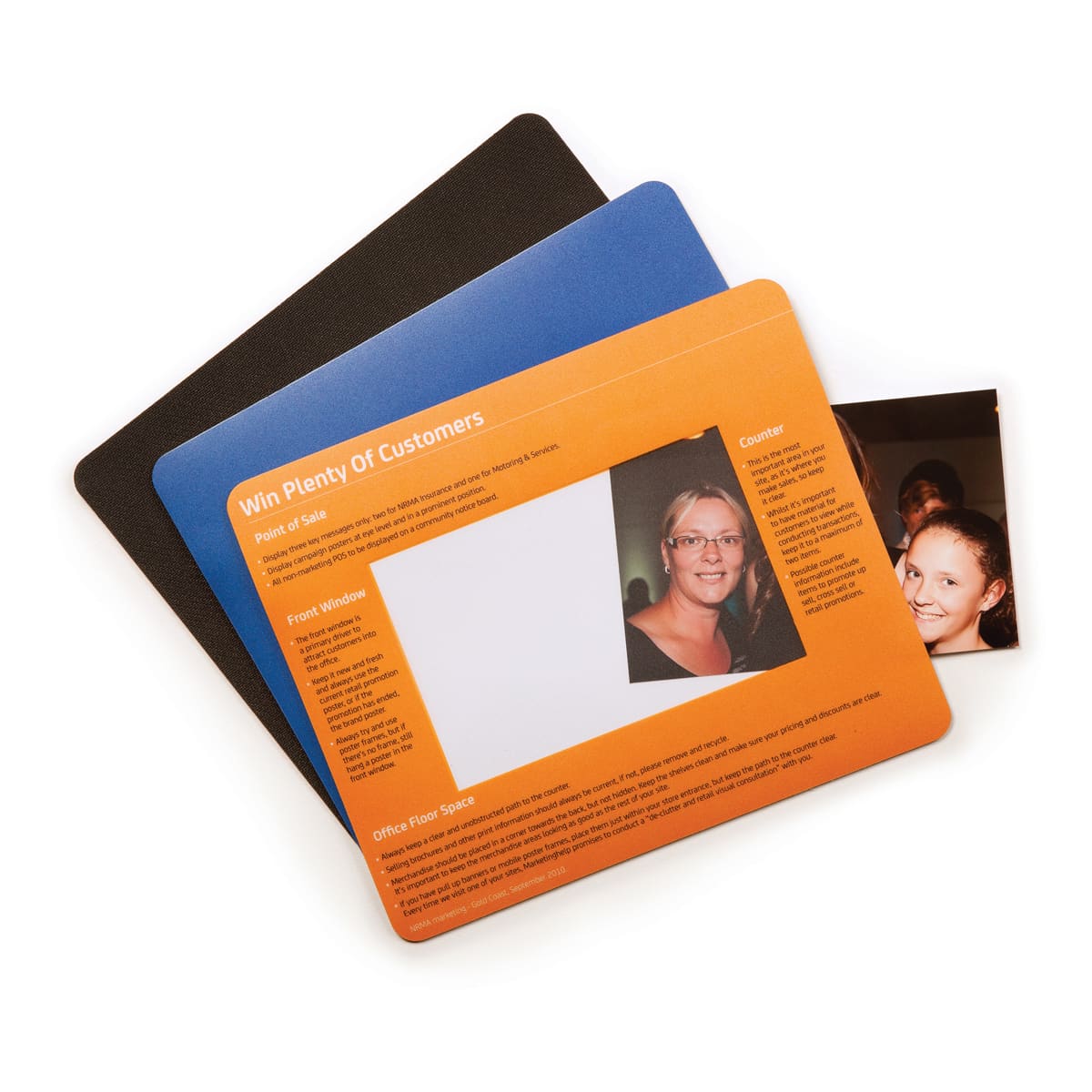 A set of three mouse mats in black, blue, and orange, featuring a photo window on the orange mat.