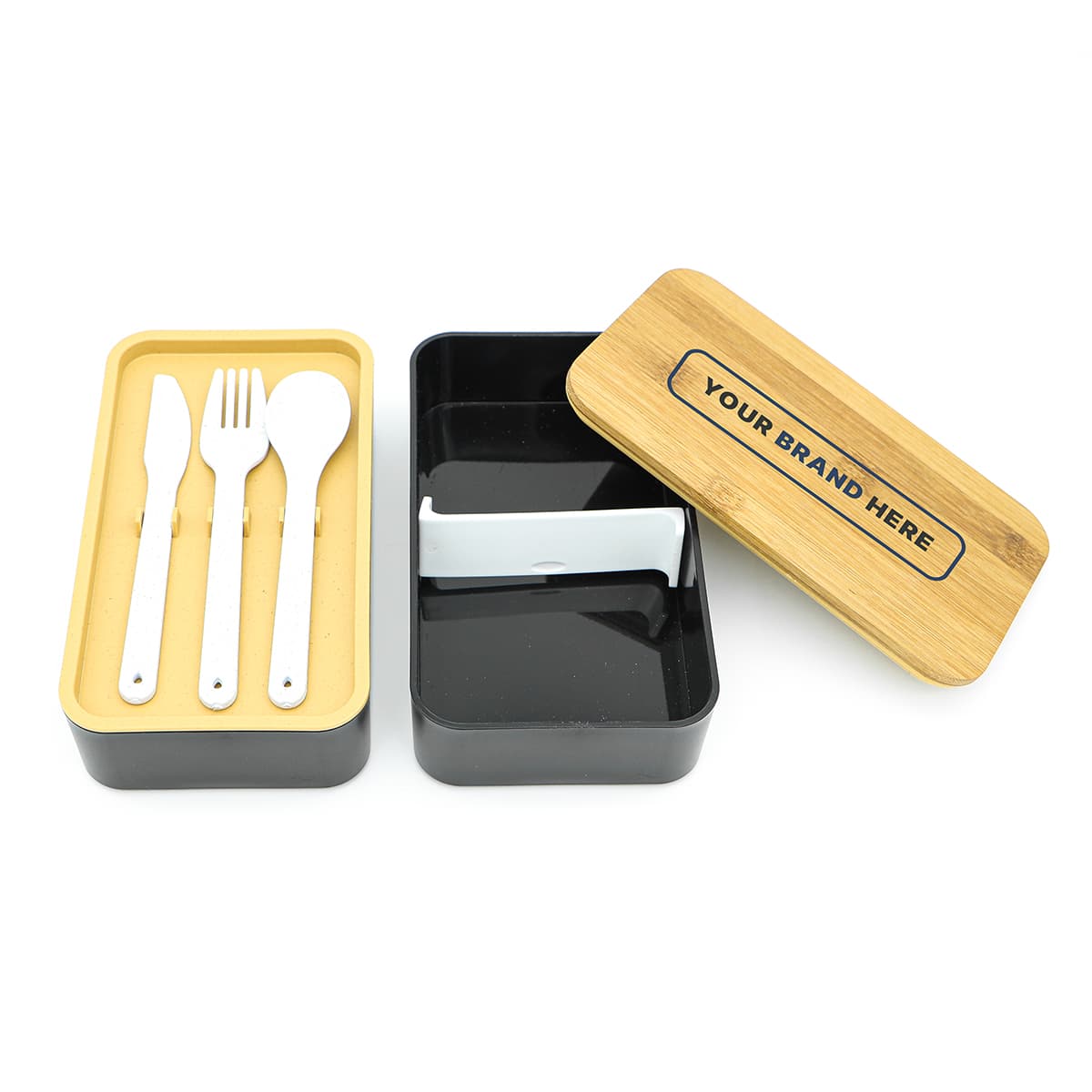 A two-layer lunch box featuring a black and bamboo design, containing cutlery including a knife, fork, and spoon.