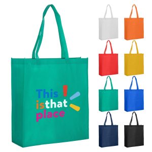 A green reusable grocery bag with a logo, displayed alongside bags in white, orange, red, yellow, blue, and black.