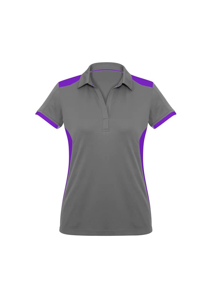 A women's polo shirt in grey with purple accents, featuring a collar and short sleeves. It includes a logo.