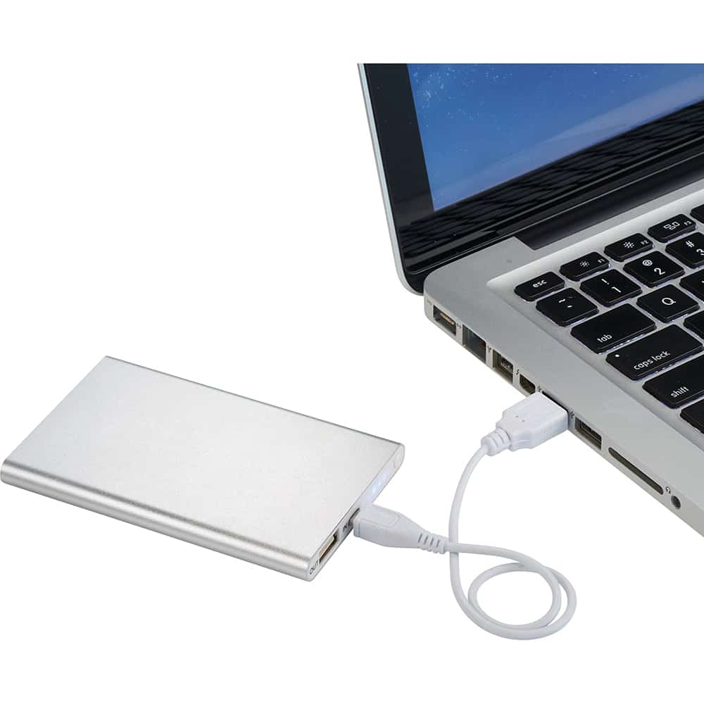 A silver 4000 mAh powerbank charger connected to a laptop via a white USB cable. It has a logo on the surface.