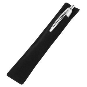 A black velvet pouch containing a pen, positioned on a desk with a keyboard and a plant.