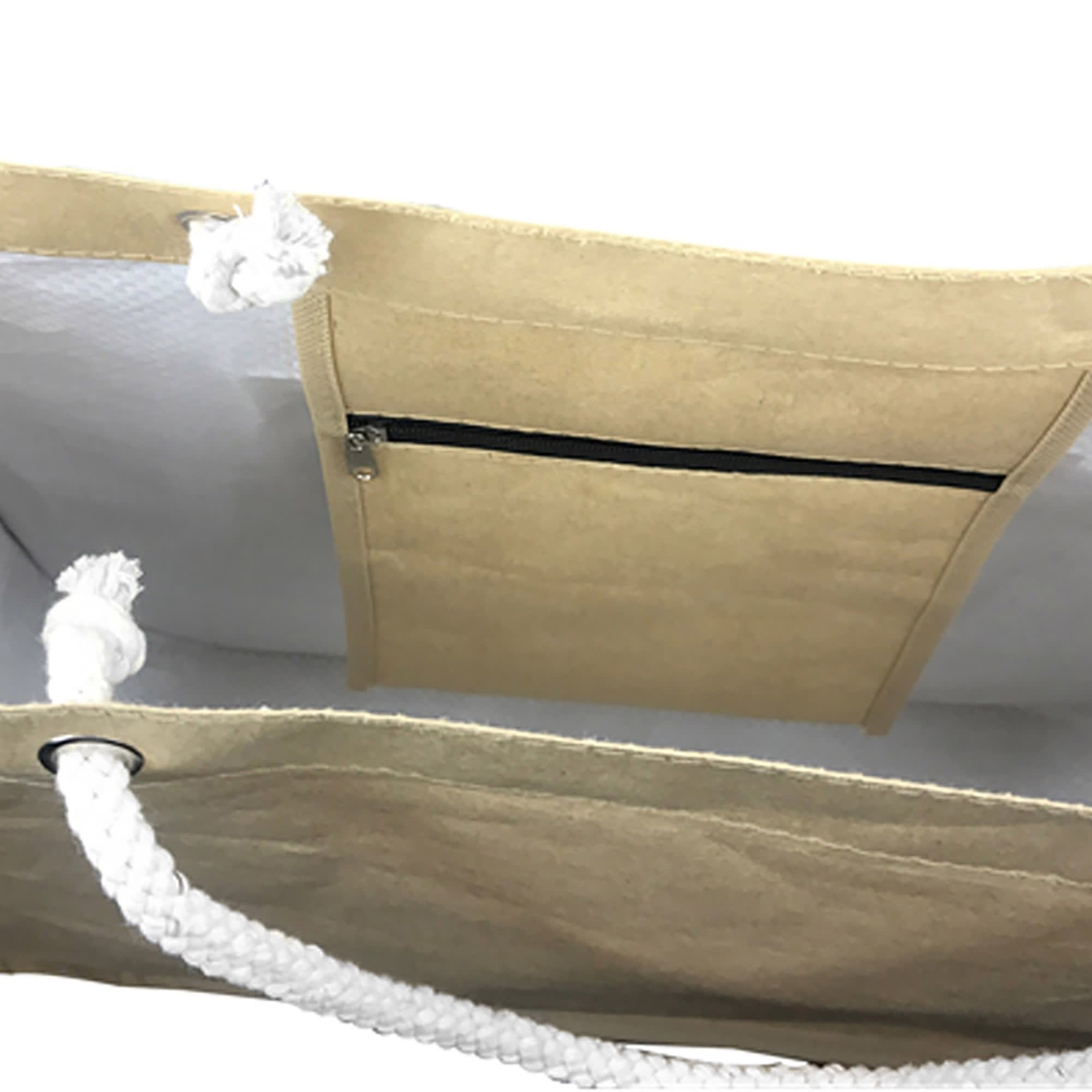 A beige paper bag with round corners, featuring a white rope handle and an interior zippered pocket.
