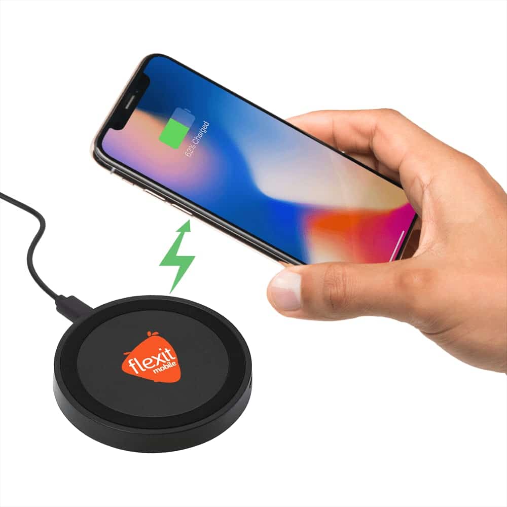 A black wireless charging pad with a logo and a hand holding a smartphone displaying a charging icon.