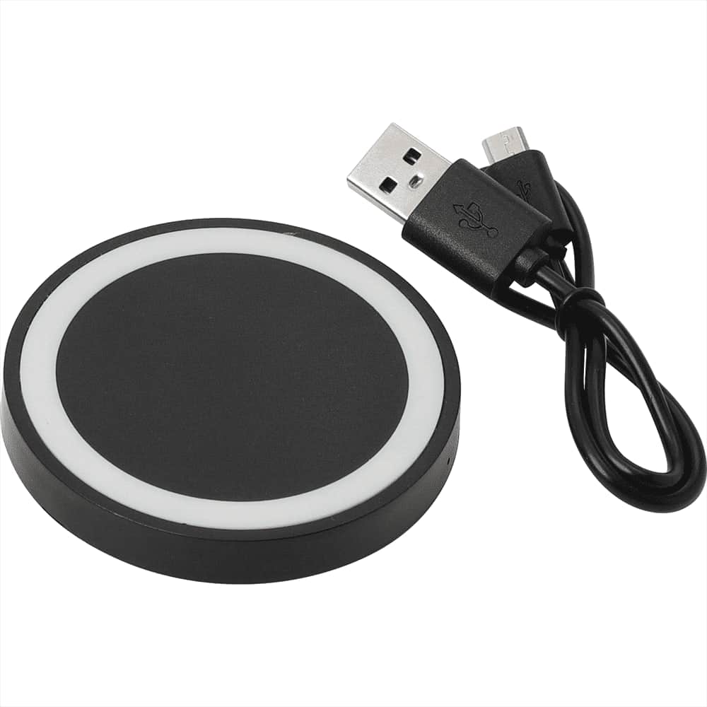 A black wireless charging pad with a white rim, accompanied by a USB charging cable.