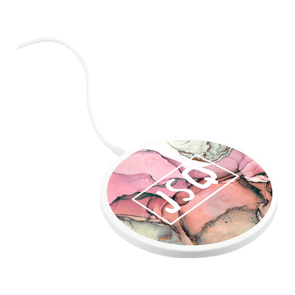 A round, ultra-thin wireless charging pad in pink and green tones with a white cable and a logo.