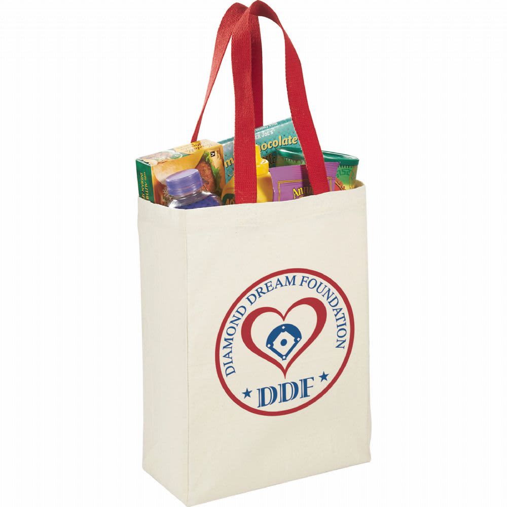 A natural cotton grocery tote in cream with red handles, featuring a logo and filled with assorted grocery items.