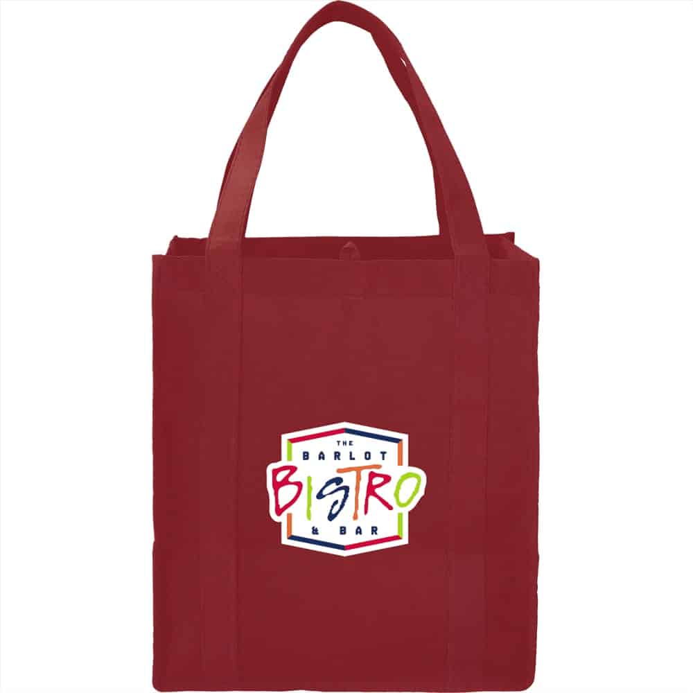 A red non-woven grocery tote bag with sturdy straps and a logo on the front.