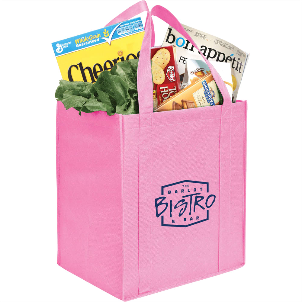 A pink non-woven grocery tote filled with lettuce, cereal, and snack boxes, featuring a logo on the front.