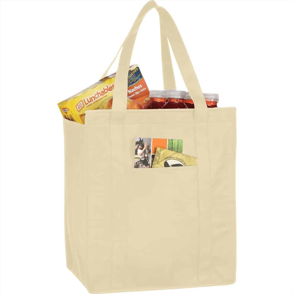 A beige insulated grocery tote filled with snacks and drinks, featuring a front pocket and sturdy handles.
