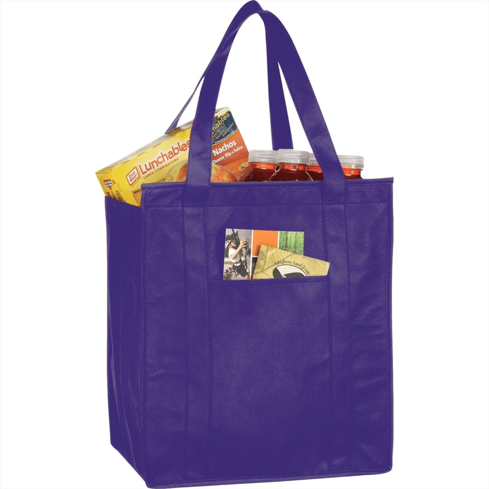 A purple insulated grocery tote filled with snacks, drinks, and a small item peeking out from the front pocket.