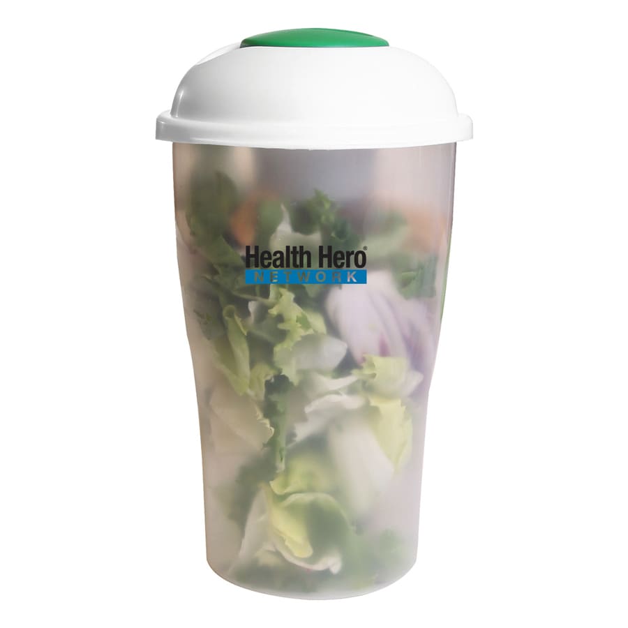 A transparent salad shaker with a white lid and green top, filled with fresh salad ingredients. It features a logo.