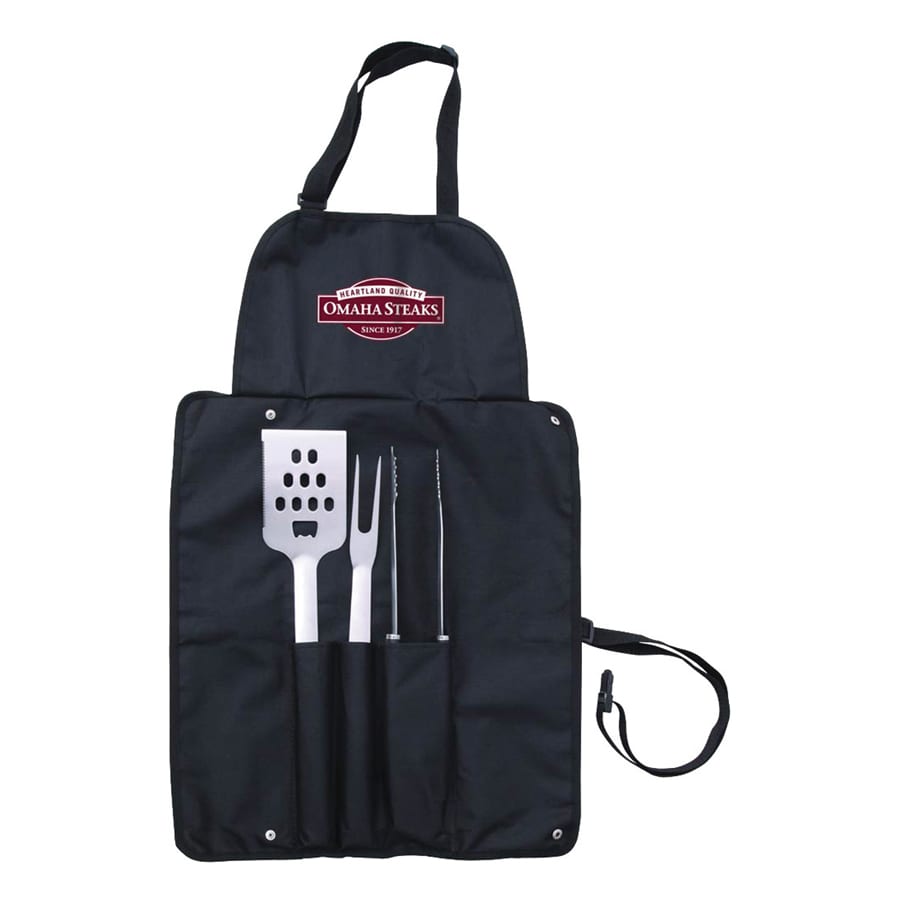 A black apron with a logo, featuring a spatula, fork, and slicing knife in pockets.