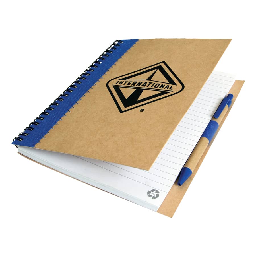 A recycled paper notebook with a brown cover, blue spiral binding, and a pen attached. It features a logo on the front.