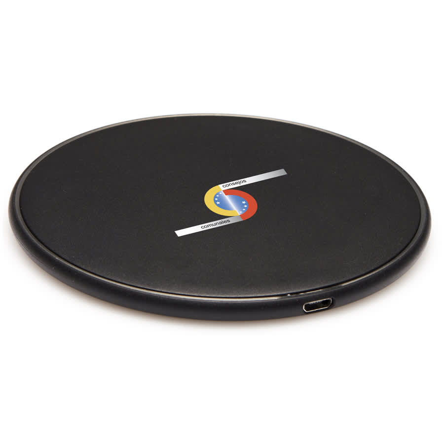 A round black wireless charging dock with a USB-C port and a prominent logo on the surface.