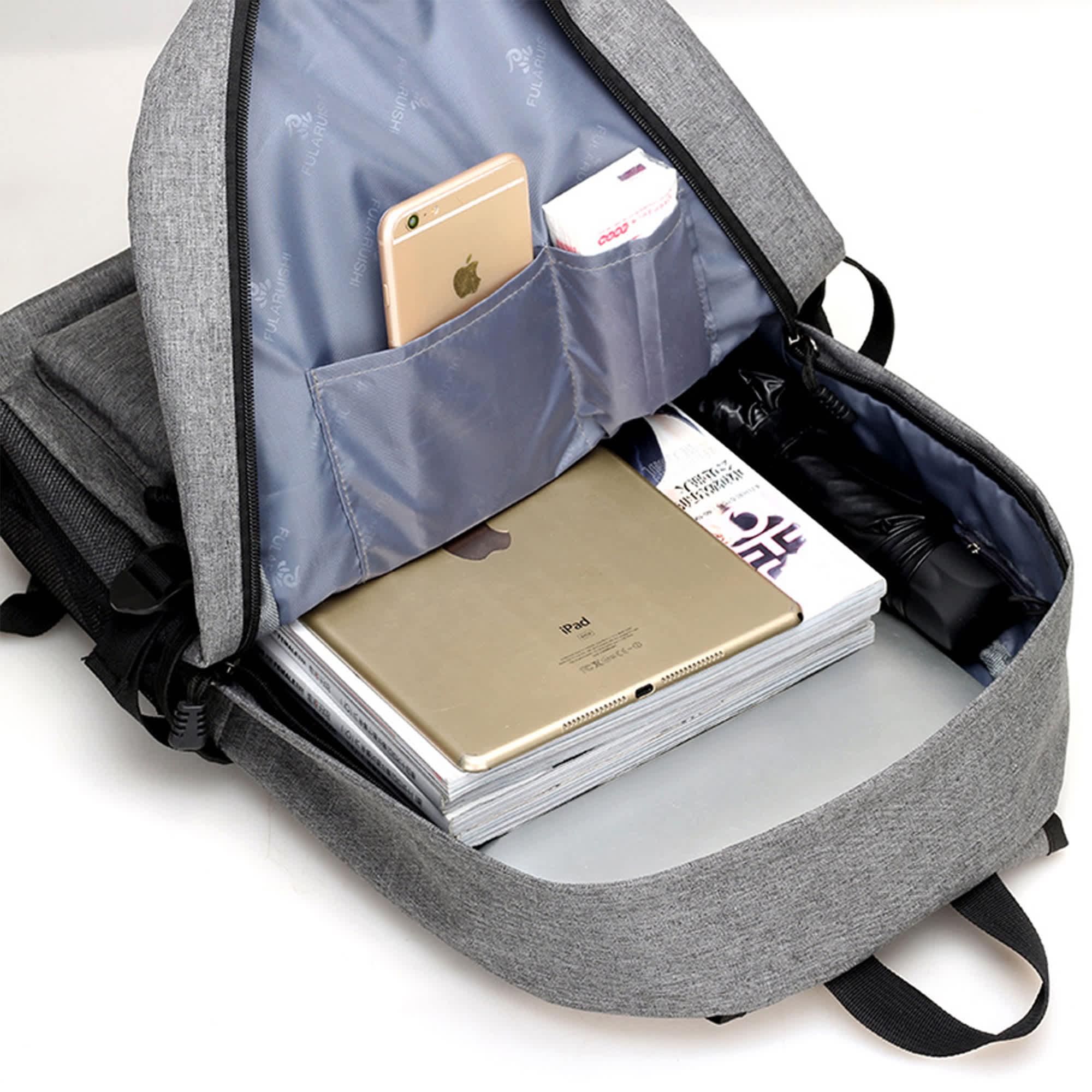 A grey laptop backpack with compartments for a laptop, tablet, phone, and other items. It features a logo.