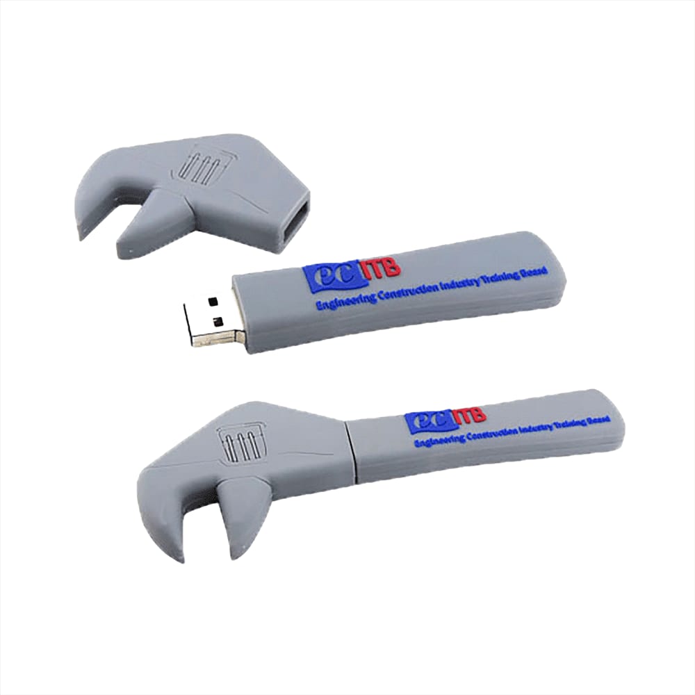 A grey USB flash drive shaped like a wrench, featuring a logo and removable cap.