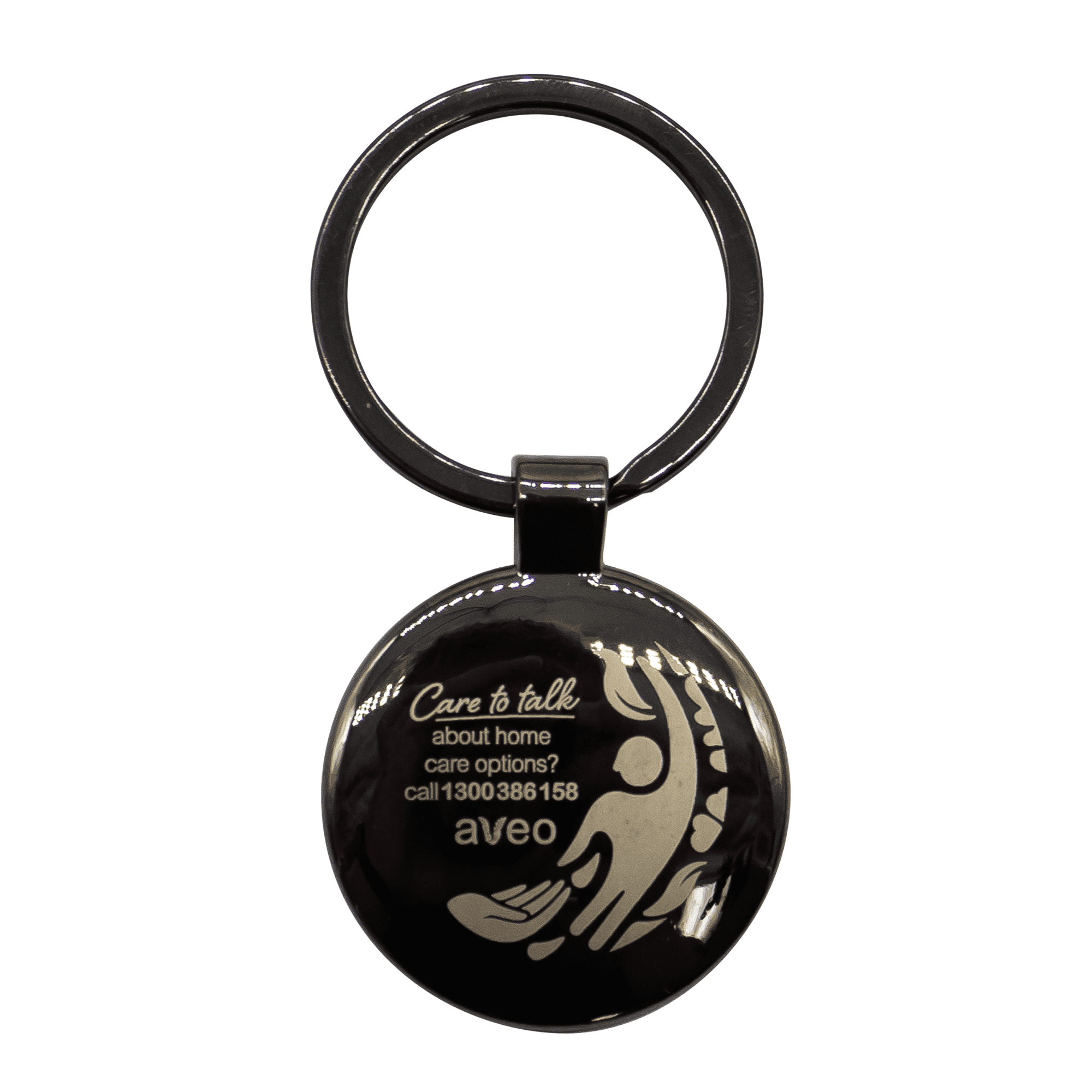 A gunmetal keychain featuring a circular shape and a design, with a branded logo.