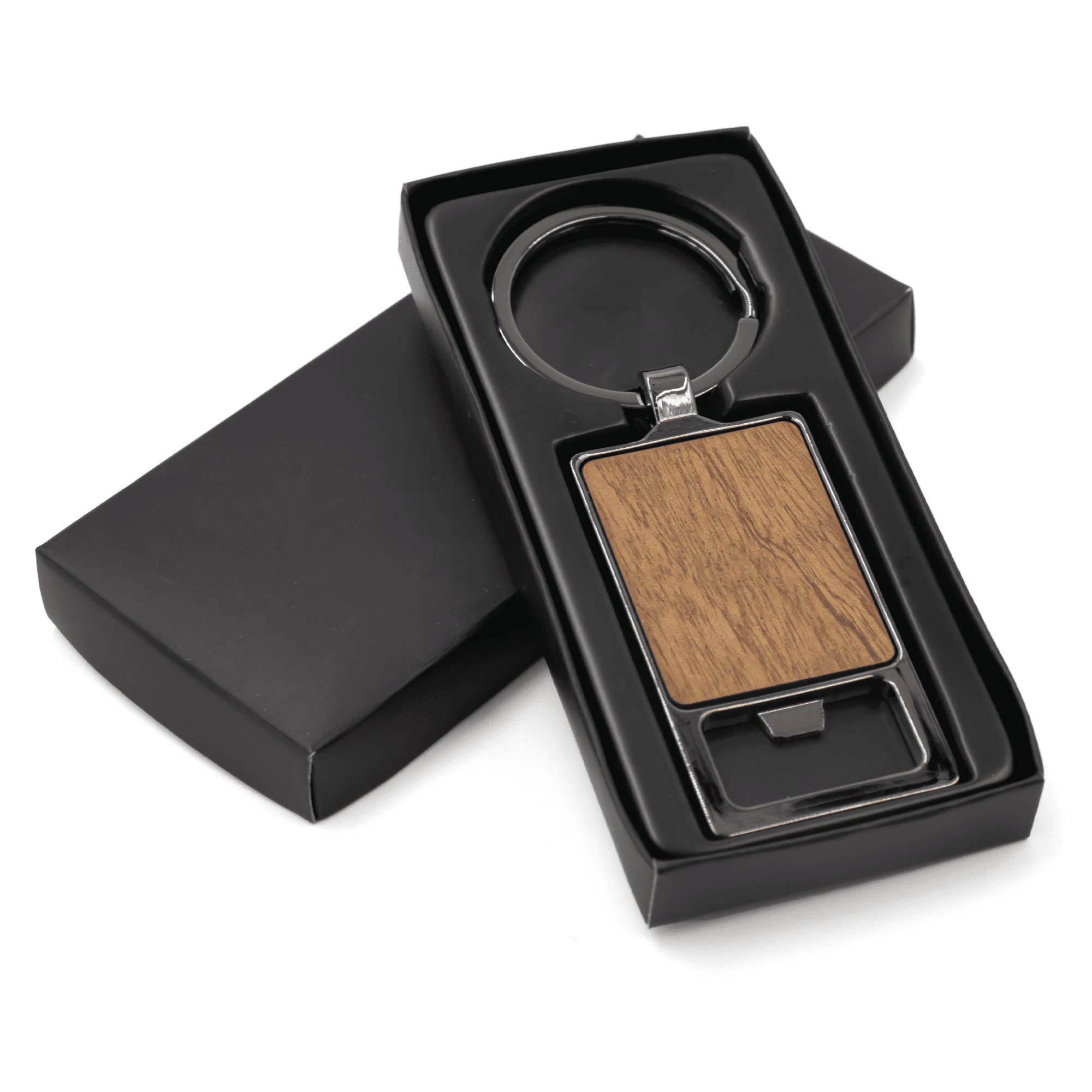 A rectangular keychain with a wooden panel, presented in a black box. The keychain has a metal ring and a sleek design.