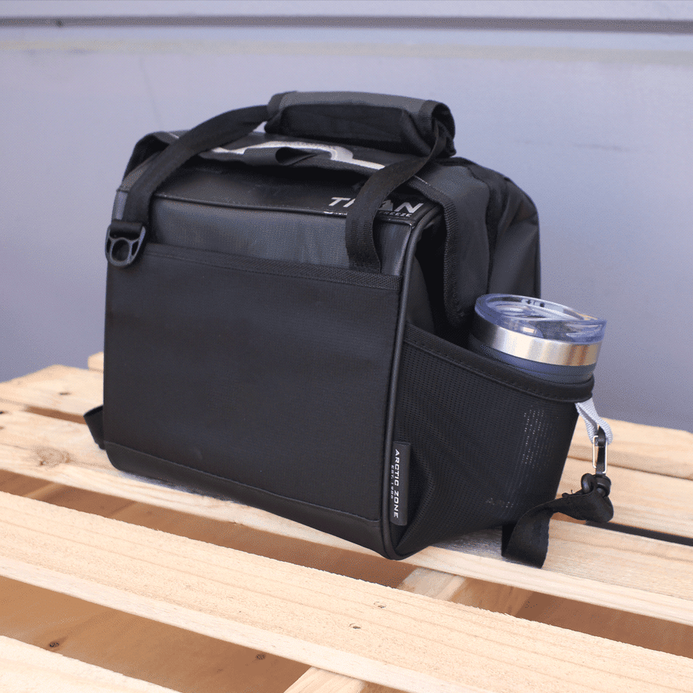 A black lunch cooler featuring a grey handle and shoulder strap, with a logo on the front.
