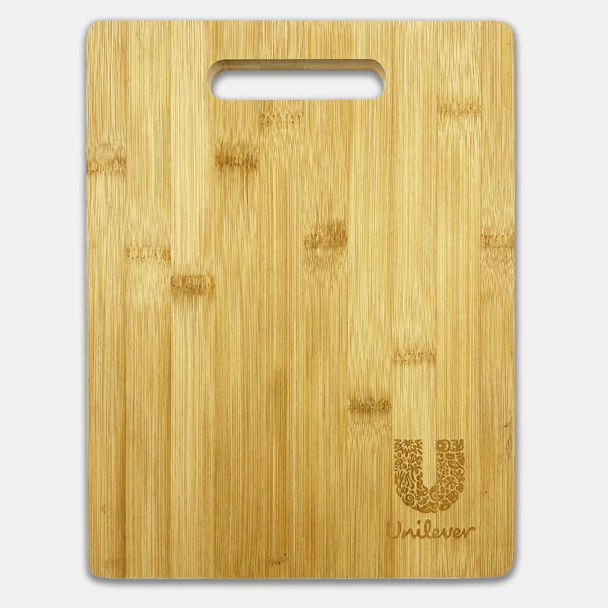 A bamboo chopping board with a handle, featuring a subtle logo in the corner. It has a natural wood finish.