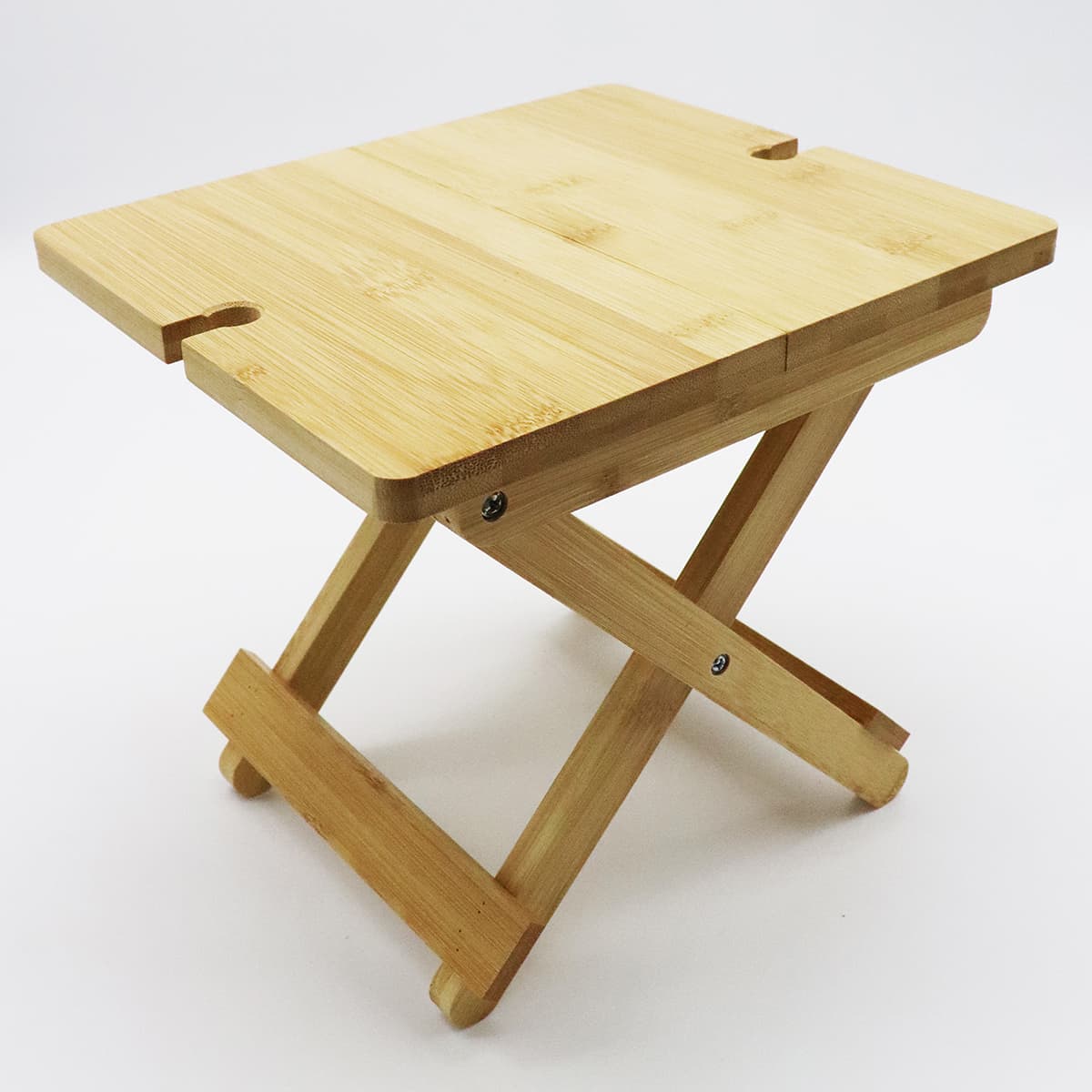 A bamboo folding table with a natural finish and a sturdy, collapsible design. It has cutouts on the surface.