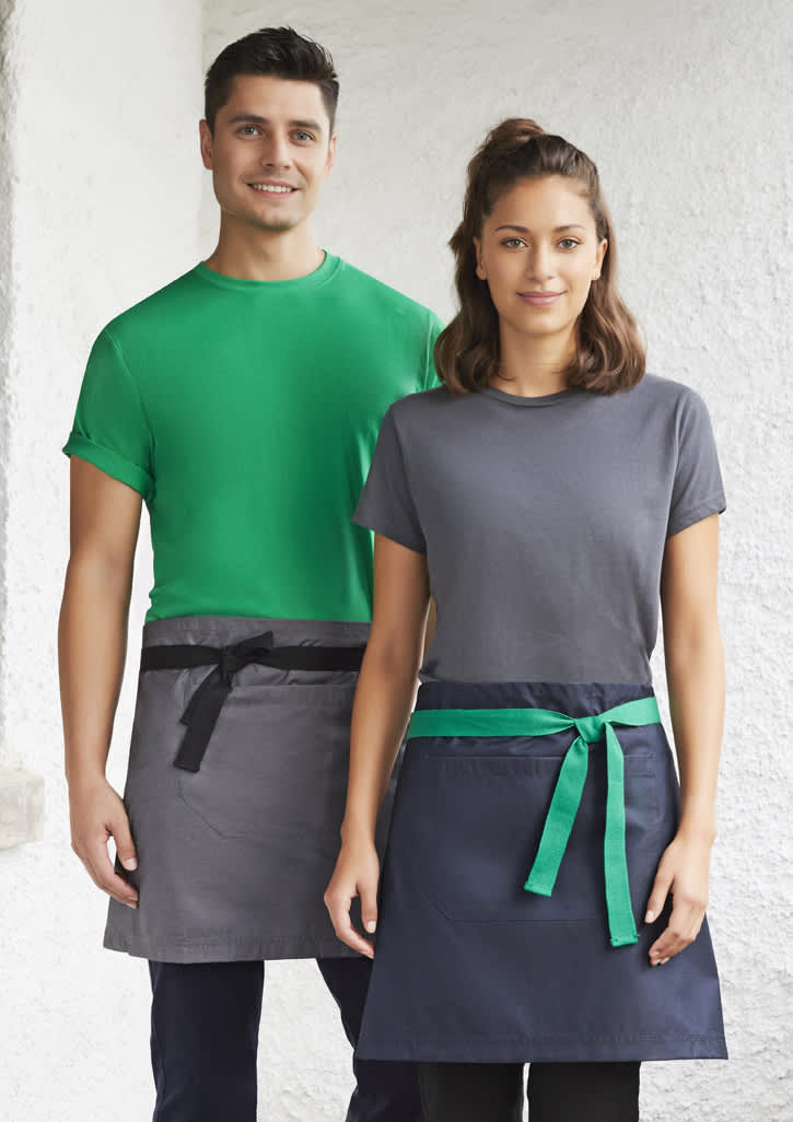 A green and navy urban waist apron worn by two models, featuring contrasting ties and a logo on one apron.