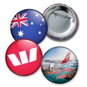 Four button badges featuring an Australian flag, a red logo, and an image of a Qantas A380, with a metallic backing.