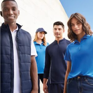 A group of four people wearing various blue uniforms and outerwear, with one person in a navy vest and another in a cap.