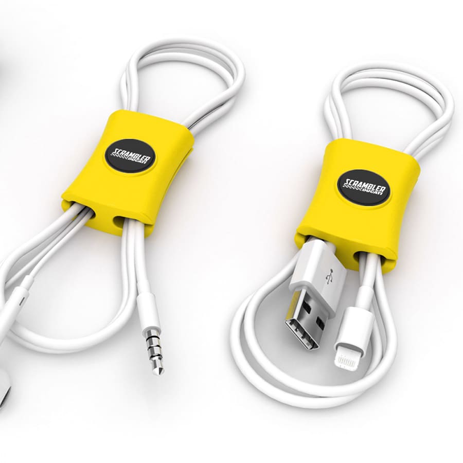 A yellow cable manager designed to tidy audio and charging cables, featuring a circular logo.