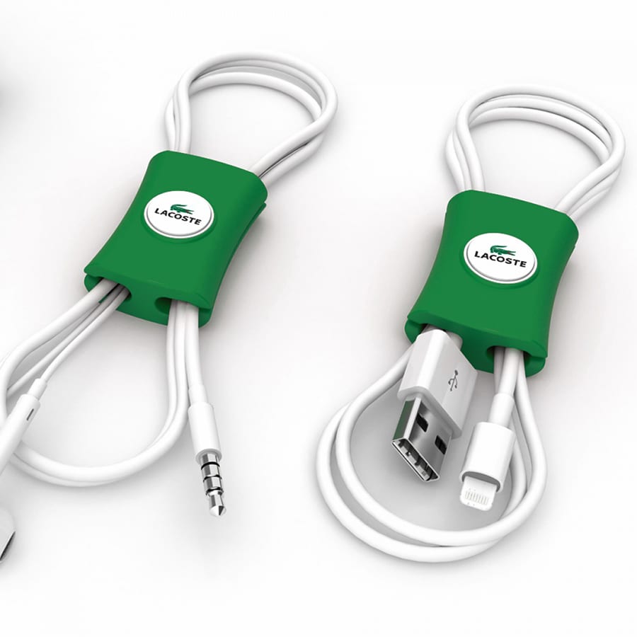 A green cable manager featuring two white cables neatly organised, with a logo on the centre.