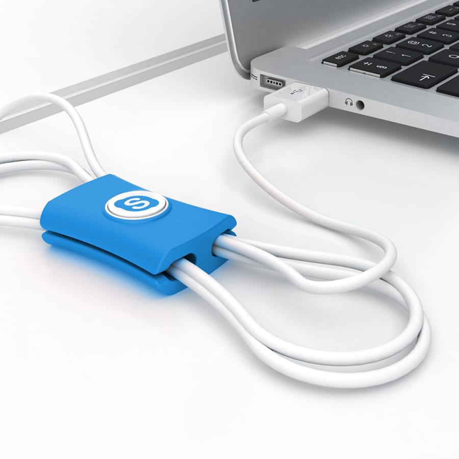 A blue cable manager with a logo, organising white cables near a laptop USB port.