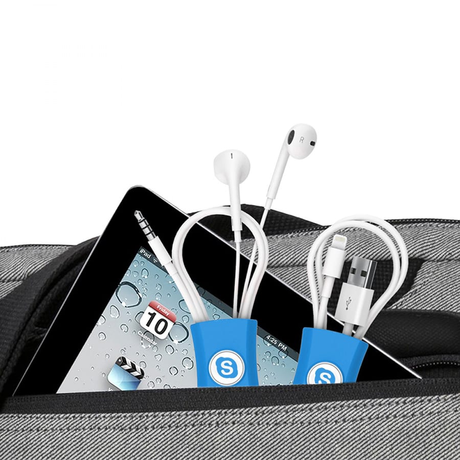 A cable manager in blue, holding earphones and charging cables, nestled in a bag with an iPad peeking out.