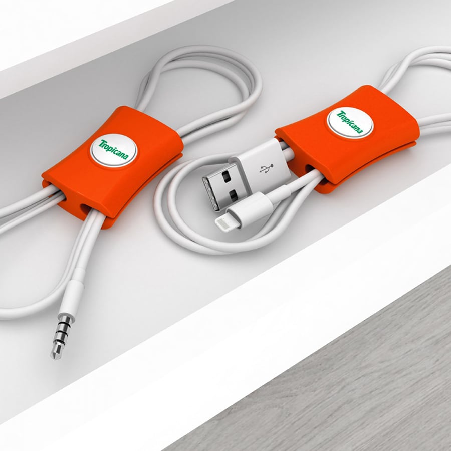 An orange cable manager with slots for holding various cables neatly in place. It features a logo.